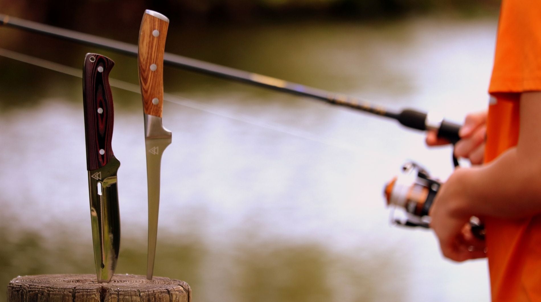 Boy in orange shirt fishing in the outdoors with two Kratos Hunting Knives in view