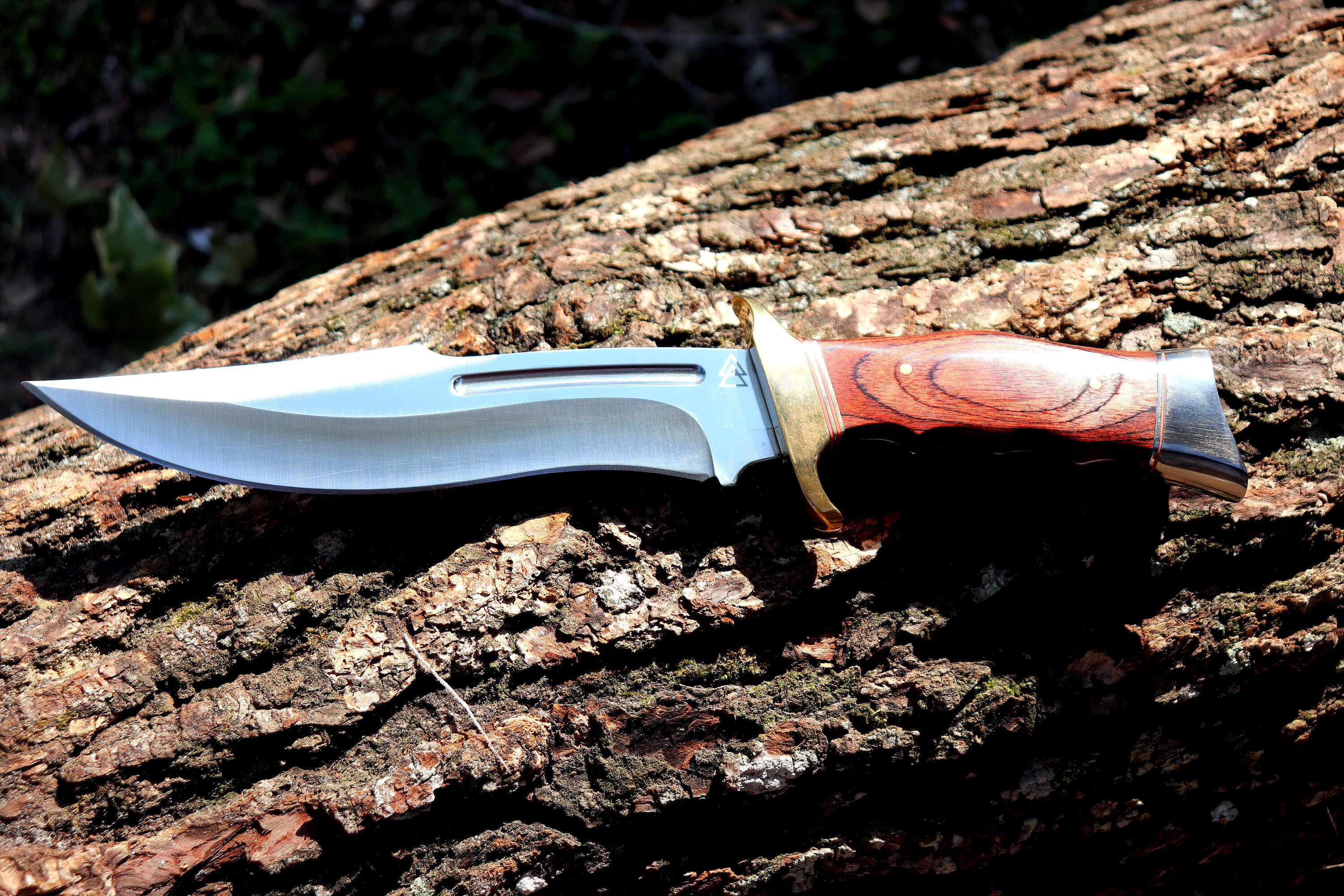 Kratos hunting knife on top of a tree log